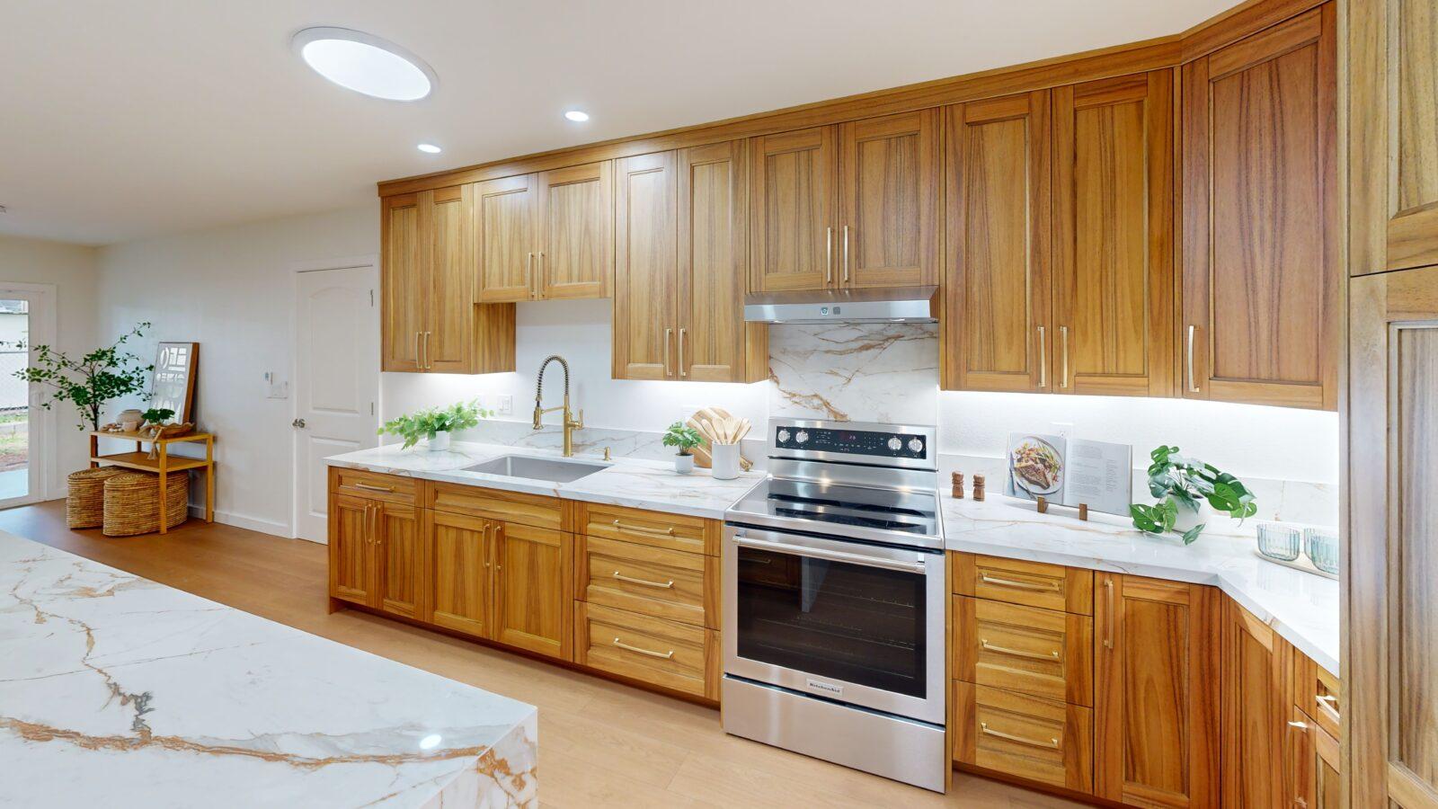 Custom-designed kitchen featuring wood cabinetry, quartz countertops, modern appliances, and premium finishes in a newly built Hawaii home.